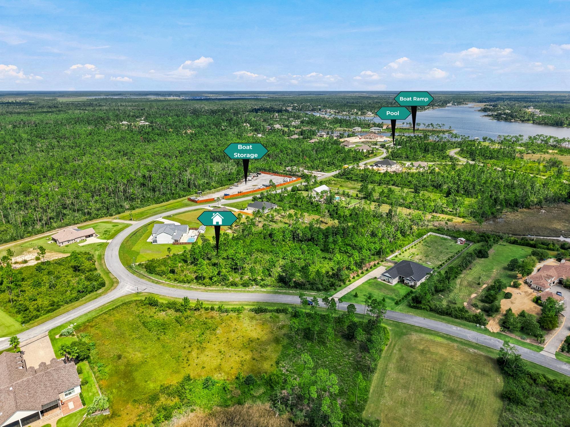 Aerial view of a lakeside subdivision with lot drop pins, photographed on the Florida Panhandle