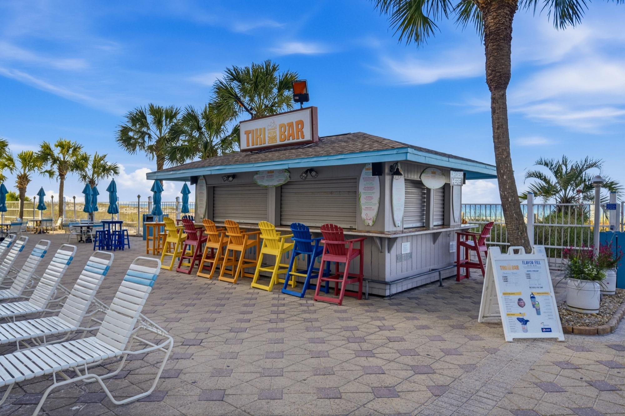 Beachside tiki bar with colorful bar stools, photographed on the Florida Panhandle
