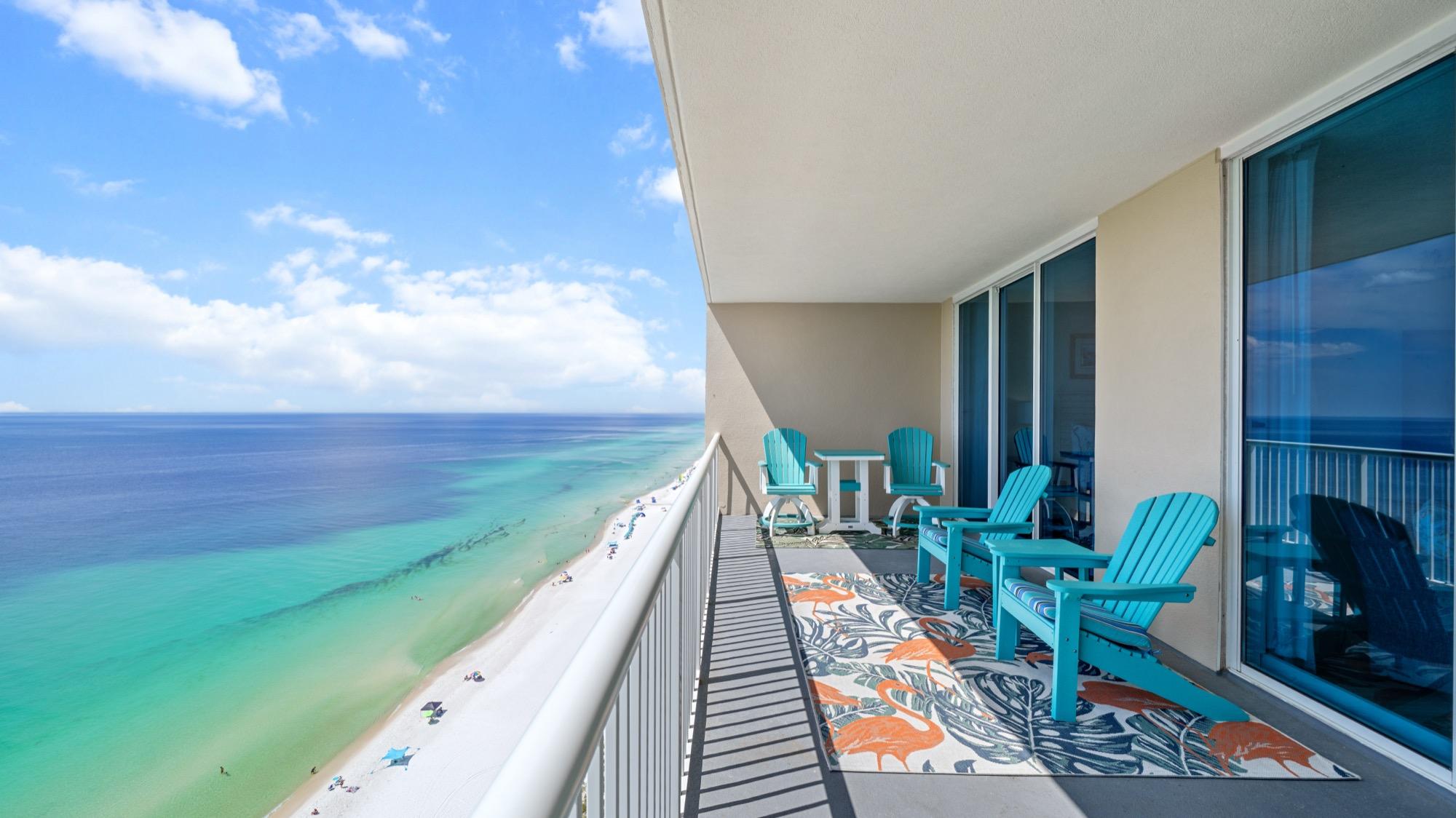 Long balcony with turquoise Adirondack chairs above the beach, photographed on the Florida Panhandle